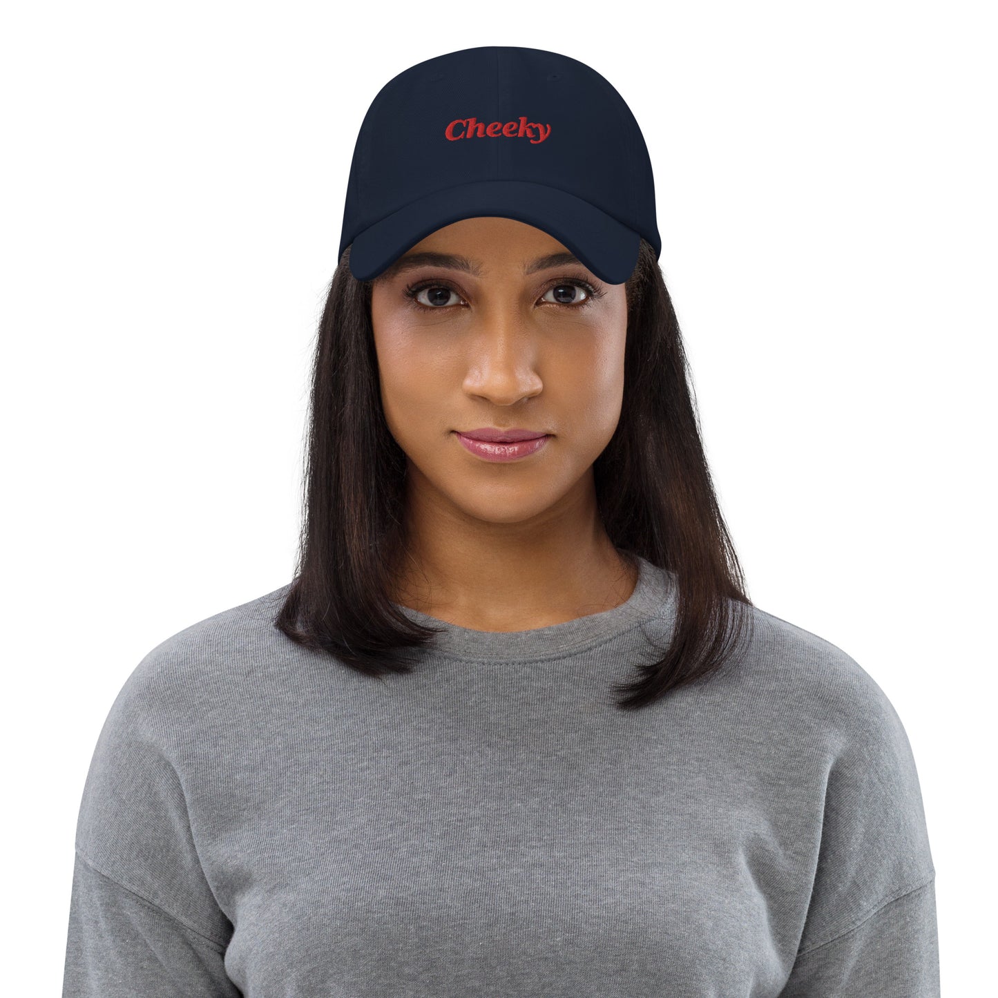 London city editions with “Cheeky” type in red embroidery on navy casual dad hat front view on female model