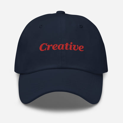 London city editions with “Creative” type in red embroidery on navy casual dad hat front view on white background