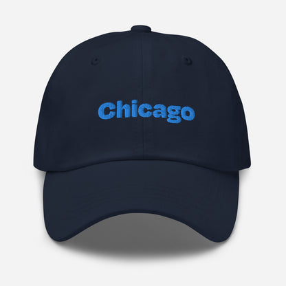 Chicago city editions with “Chicago” type in blue embroidery on navy casual dad hat front view on white background