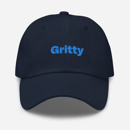 Chicago city editions with “Gritty” type in blue embroidery on navy casual dad hat front view on white background