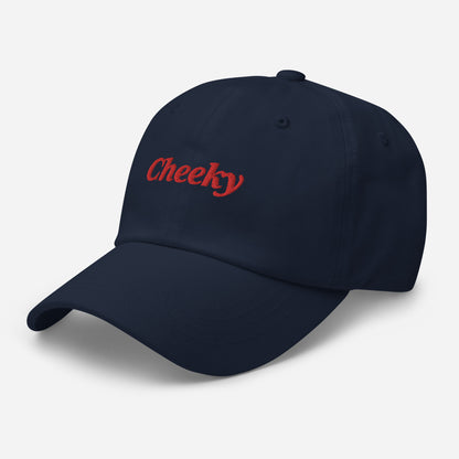 London city editions with “Cheeky” type in red embroidery on navy casual dad hat front side view on white background