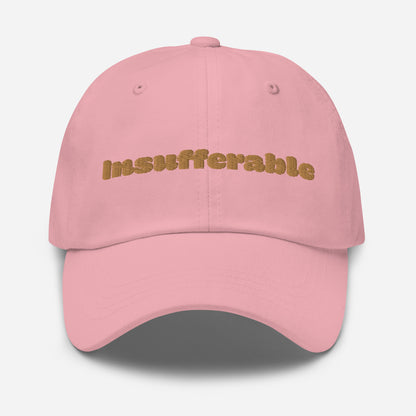 Los Angeles city editions with “Insufferable” type in gold embroidery on pink casual dad hat front view on white background