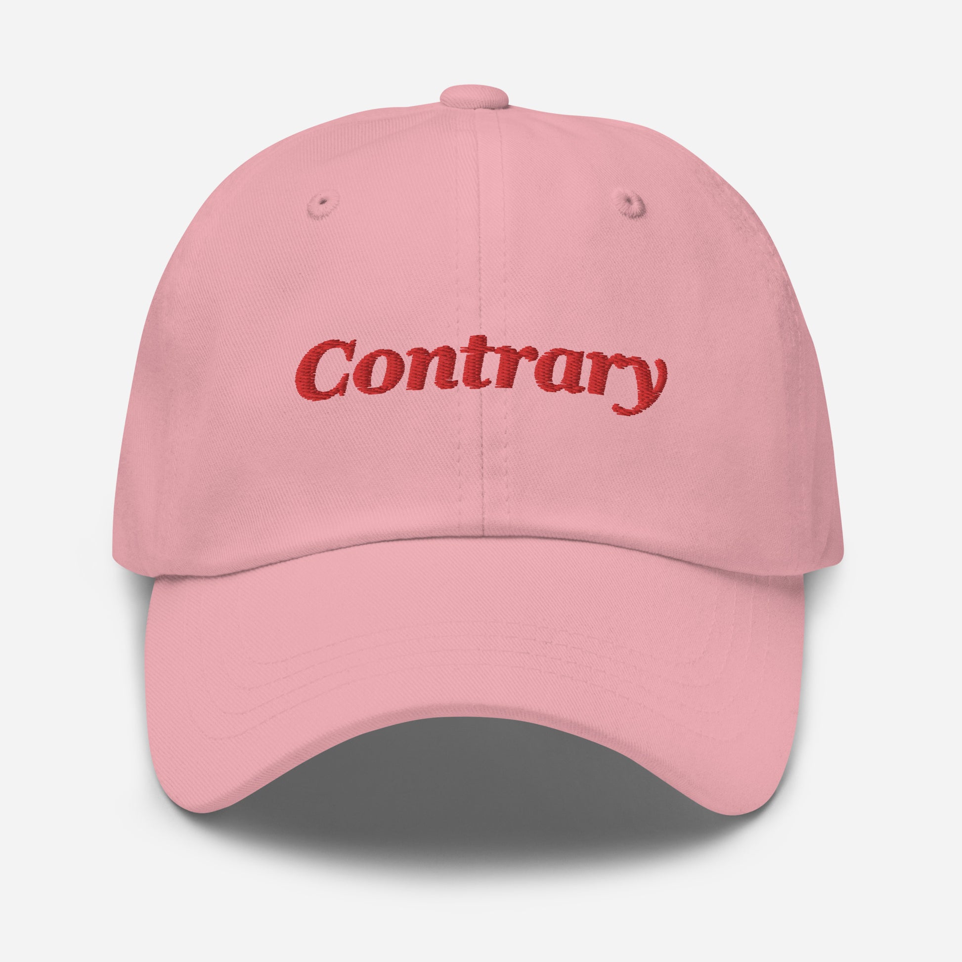 London city editions with “Contrary” type in red embroidery on pink casual dad hat front view on white background