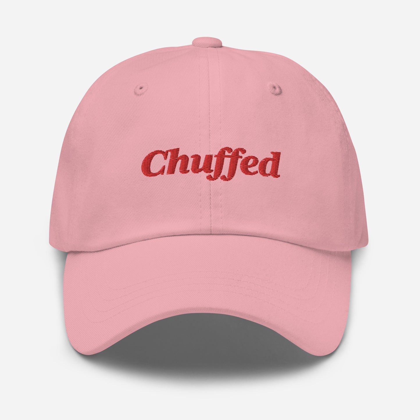 London city editions with “Chuffed” type in red embroidery on pink casual dad hat front view on white background