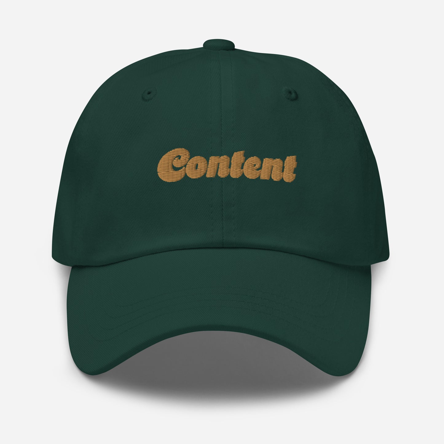 Portland city editions with “Content” type in gold embroidery on green casual dad hat front view on white background