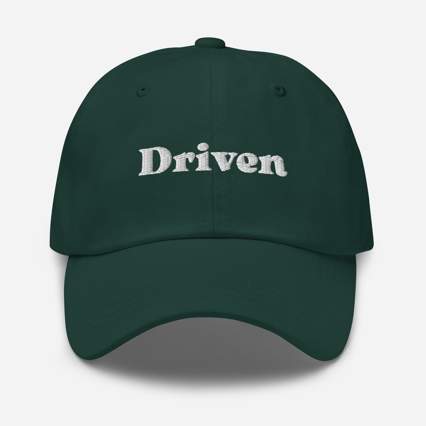 New York city editions with “Driven” type in white embroidery on green casual dad hat front view on white background