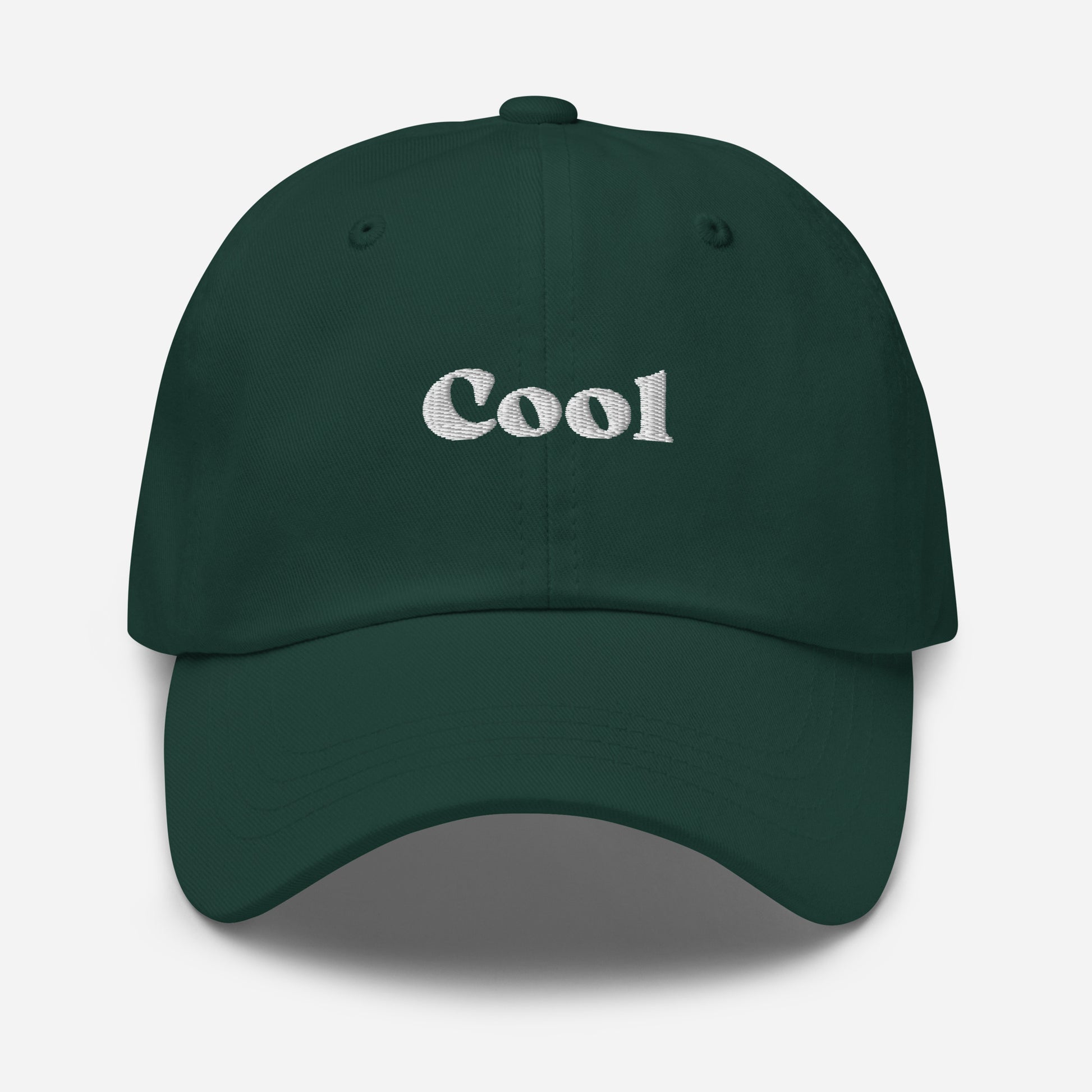 New York city editions with “Cool” type in white embroidery on green casual dad hat front view on white background