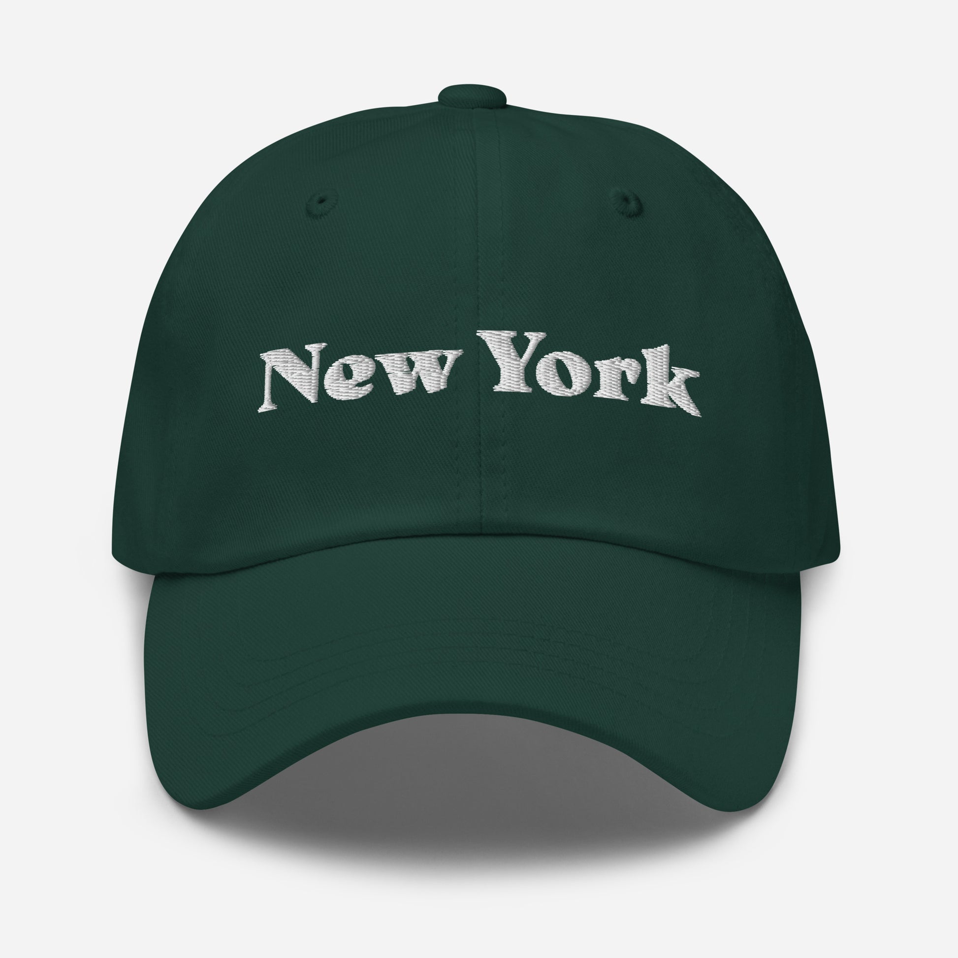 New York city editions with “New York” type in white embroidery on green casual dad hat front view on white background