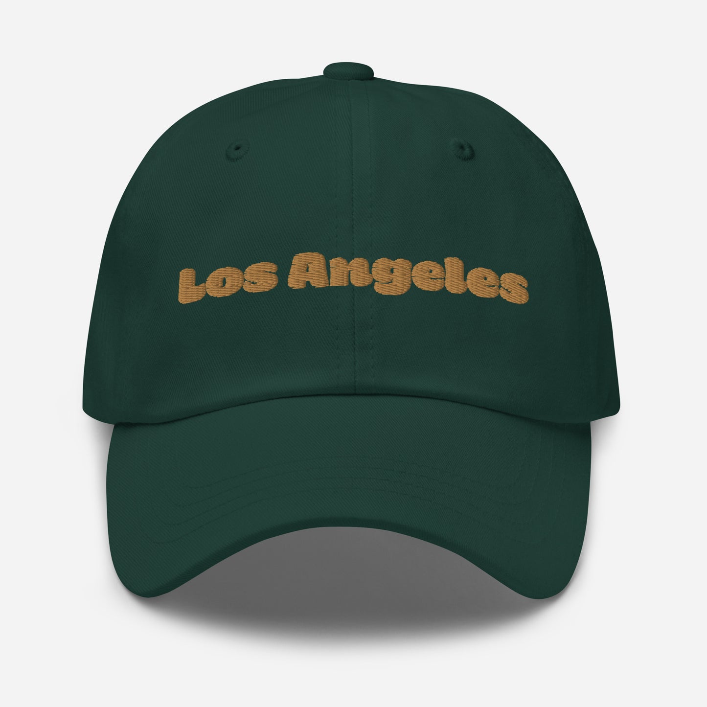 Los Angeles city editions with “Los Angeles” type in gold embroidery on green casual dad hat front view on white background