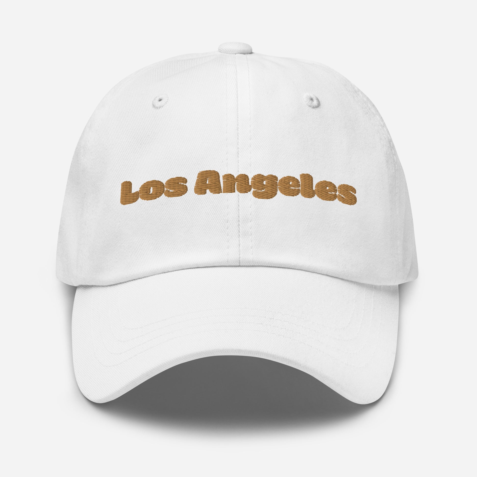 Los Angeles city editions with “Los Angeles” type in gold embroidery on white casual dad hat front view on white background