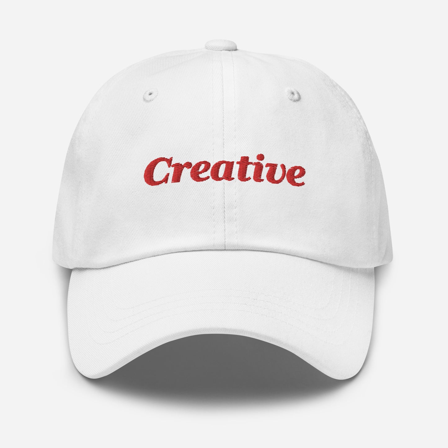 London city editions with “Creative” type in red embroidery on white casual dad hat front view on white background