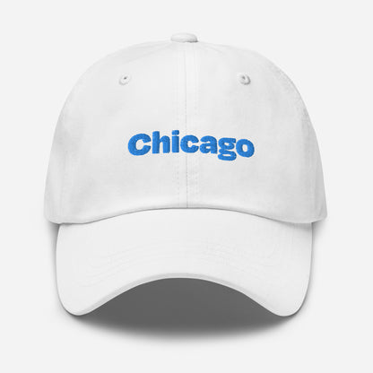 Chicago city editions with “Chicago” type in blue embroidery on white casual dad hat front view on white background