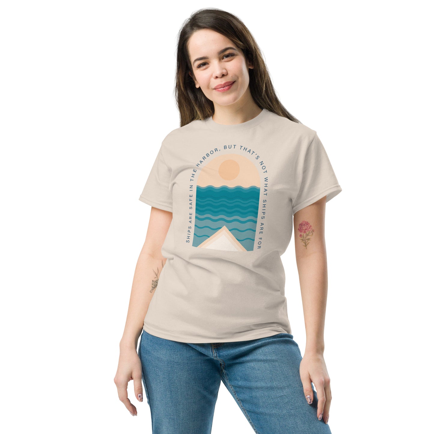 Ships Are Safe In The Harbor, But That's Not What Ships Are For text on beige t-shirt, front view on female model