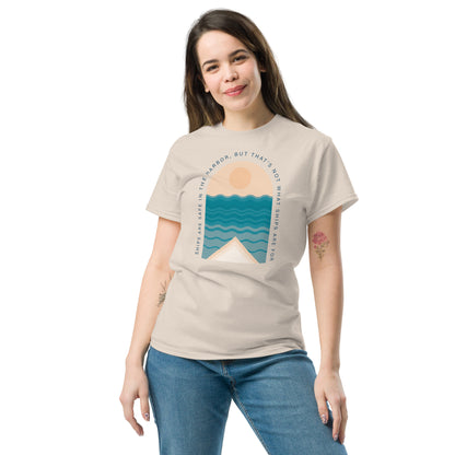 Ships Are Safe In The Harbor, But That's Not What Ships Are For text on beige t-shirt, front view on female model